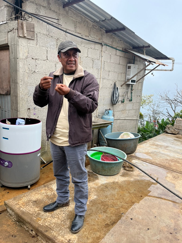 Hermenegildo Marin standing on his coffee processing patio