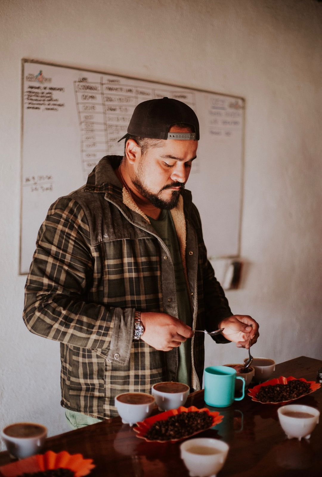 Jose Arguello cupping coffee in his coffee lab