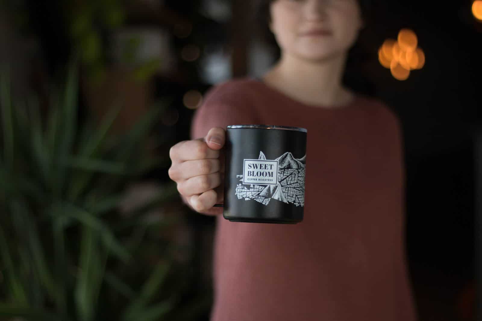 barista holding black mug
