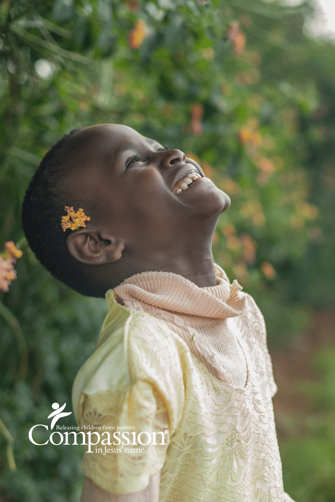 Kenyan girl smiling with flower behind ear